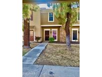 Tan two-story home with a red door and landscaping at 3329 W Mcrae Way # 4, Phoenix, AZ 85027