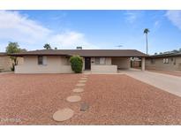 Single story home with a landscaped front yard and stone pathway at 3815 E Cortez St, Phoenix, AZ 85028