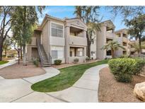 Two-story apartment building with landscaped grounds and walkways at 3830 E Lakewood E Pkwy # 2047, Phoenix, AZ 85048