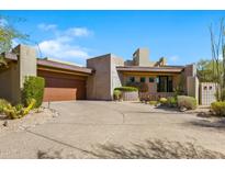 Contemporary home with a large driveway and desert landscaping at 39349 N 107Th Way, Scottsdale, AZ 85262