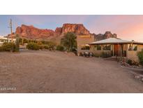 Desert landscape home with mountain views, welcoming entryway, and charming patio at 6013 E Lost Dutchman Blvd, Apache Junction, AZ 85119