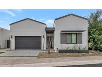 Modern home with a two-car garage and desert landscaping at 6147 E Alta Hacienda Dr, Scottsdale, AZ 85251