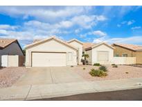 Single-story house with a two-car garage and desert landscaping at 7138 E Laguna Azul Ave, Mesa, AZ 85209