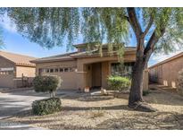 One-story house with tan exterior, two-car garage, and landscaping at 7419 S 31St Dr, Phoenix, AZ 85041