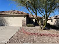 House exterior with a two-car garage and landscaping at 1120 S 232Nd Ave, Buckeye, AZ 85326