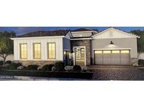 Craftsman style home with stone and white siding, three-car garage, and landscaped yard at 1161 E Peach Tree Dr, Chandler, AZ 85249