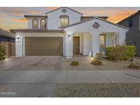 Two-story house with brown garage door and landscaping at 14428 W Faye Way, Surprise, AZ 85387