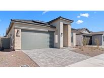 Charming single-story home with a two car garage, stone accents, paver driveway and low maintenance landscaping at 20316 W Turney Ave, Buckeye, AZ 85396
