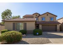 Two-story house with brown garage doors and landscaping at 21391 E Camina Plata --, Queen Creek, AZ 85142