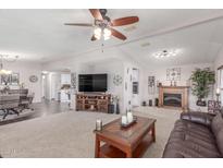 Spacious living room with a fireplace and large TV at 2233 E Behrend Dr # 234, Phoenix, AZ 85024