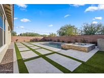 Spacious backyard oasis featuring a sparkling pool, hot tub, and expansive patio at 34801 N 53Rd St # 10, Cave Creek, AZ 85331