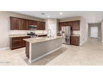 Kitchen boasts granite countertops and stainless steel appliances at 3583 N Brooklyn Dr, Buckeye, AZ 85396