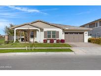One-story home with a covered porch, two-car garage, and landscaping at 3620 E Austin Dr, Gilbert, AZ 85296