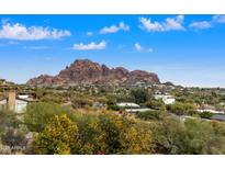 Aerial view of a home with a pool, showcasing the property's landscaping and mountain backdrop at 4222 E Mcdonald Dr, Paradise Valley, AZ 85253