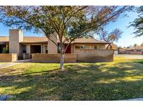 Brick house with a red door and well-maintained lawn at 6421 S Stanley Pl # C, Tempe, AZ 85283