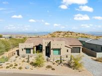 Aerial view of a house with a pool and landscaped backyard, mountain views at 13222 E Ranch Gate Rd, Scottsdale, AZ 85255