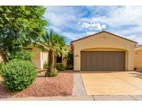 Single-story home with a two-car garage and desert landscaping at 13827 W Junipero Dr, Sun City West, AZ 85375