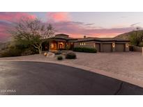 Stunning desert home with a circular driveway and desert landscaping at 14216 S Canyon Dr, Phoenix, AZ 85048