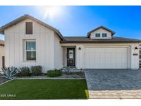 White farmhouse exterior with landscaping, driveway, and two-car garage at 17155 W Gracemont St, Surprise, AZ 85388