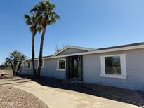 Charming single-story home featuring a quaint entrance, modern windows and lush landscaping, blending comfort with curb appeal at 22183 N 178Th Ave, Surprise, AZ 85387