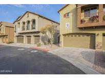 Two-story townhome with attached garage and landscaped front at 2250 E Deer Valley Rd # 48, Phoenix, AZ 85024