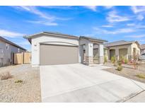 New construction home exterior with a two-car garage and landscaped front yard at 23120 E Twilight Dr, Queen Creek, AZ 85142