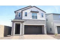 Charming two-story home with a neutral color palette, attached garage, and well-manicured landscaping at 2444 W Rowel Rd, Phoenix, AZ 85085