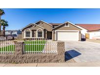 Newly built home with a two-car garage and artificial turf at 2716 N 88Th Ln, Phoenix, AZ 85037