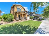 Two-story house with a landscaped yard and golf cart at 3548 E Mesquite St, Gilbert, AZ 85296