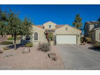 Single-story house with a two-car garage and desert landscaping at 36080 W Merced St, Maricopa, AZ 85138