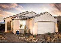 Single-story home with a two-car garage and desert landscaping at 6733 W Desert Dr, Laveen, AZ 85339