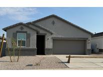 Single-story home with gray exterior, two-car garage, and small front yard at 15382 W Hackamore Dr, Surprise, AZ 85387