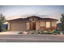 One-story home with brown roof, stone accents, and two-car garage at 17638 W Rancho Dr, Litchfield Park, AZ 85340