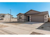 Single-story home with a two-car garage and neutral color scheme at 18411 W Monte Lindo Ln, Surprise, AZ 85387