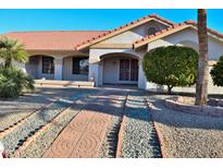 One-story home with terracotta tile roof, landscaped yard, and walkway at 20619 N Echo Mesa Dr, Sun City West, AZ 85375