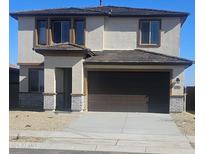 Two-story house with brown garage door and light-colored exterior at 20811 N 223Rd Ave, Surprise, AZ 85387