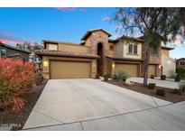 Tan two-story home with attached garage and desert landscaping at 2425 W Bronco Butte Trl # 2037, Phoenix, AZ 85085