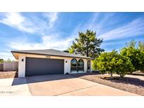 Charming single-story home featuring a two-car garage, beautiful desert landscaping, and a well-maintained front yard at 2818 S Cottonwood Dr, Tempe, AZ 85282