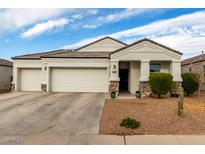 Single-story home with two-car garage, landscaping, and stone accents at 3224 N Lainey Ln, Buckeye, AZ 85396