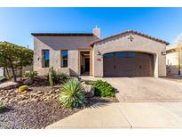 Single-story home with desert landscaping and a two-car garage at 36038 N Puente Alto Ave, Queen Creek, AZ 85140