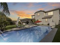 This backyard features a sparkling pool and a covered patio for outdoor living and entertaining at its finest at 3933 E Alfalfa Dr, Gilbert, AZ 85298