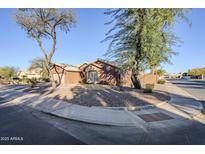 Single-story home with a two-car garage and desert landscaping at 4056 E Rosemonte Dr, Phoenix, AZ 85050