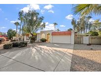 Single story home with attached garage and landscaped front yard at 4079 E Yucca St, Phoenix, AZ 85028