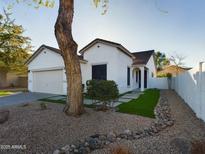 White stucco house with two-car garage and landscaped front yard at 4229 E Crest Ct, Gilbert, AZ 85298