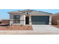 Charming single Gathering home featuring a tile roof, two car garage and low maintenance landscaping at 4817 S 251St Dr, Buckeye, AZ 85326