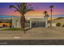 Single story home with gray garage door and landscaped front yard at 7730 E Buena Terra Way, Scottsdale, AZ 85250