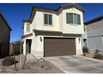 Two-story house with brown garage door and landscaping at 9408 E Supernova Dr, Mesa, AZ 85212