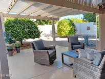 Relaxing patio with seating and shade trees at 10728 W Irma Ln, Sun City, AZ 85373