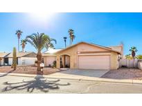 Single story home with a two-car garage and desert landscaping at 1243 E Avenida Grande --, Casa Grande, AZ 85122