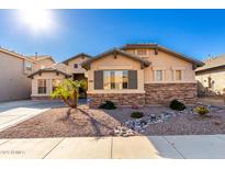 Single-story home with desert landscaping and a two-car garage at 13631 W Banff Ln, Surprise, AZ 85379